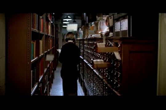 A card catalog opens itself and sprays out cards behind the librarian.