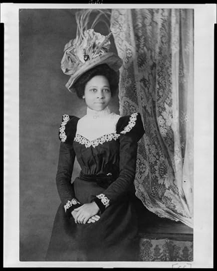 Young African American woman, three-quarter length portrait, facing slightly right, with hands folded on her lap, from African American Photographs Assembled for 1900 Paris Exposition. Library of Congress Prints and Photographs Division Washington, D.C.