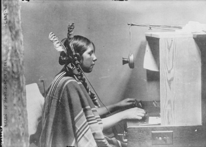 Telephone operators worked at hotels as well as at exchanges. Photographed here is Helen (last name unknown), an operator at Many Glacier Hotel in Glacier National Park in 1925. At the time, park concessionaires often required their Blackfeet employees–including bus drivers and telephone operators—to dress in “traditional” clothing to appeal to eastern tourists. Bain News Service, Library of Congress Prints and Photographs Division Washington, D.C. 