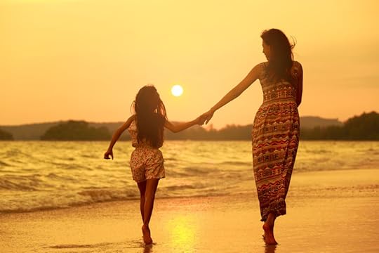 27858780 - mother and daughter walking on the beach with sunset