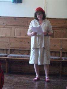 Photo of Debbie reading in the Quaker Meeting House