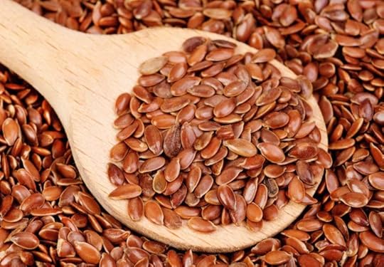 close up of flax seeds and wooden spoon food background