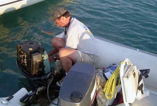 Once the Olympics begins, a coach's primary job is to eliminate distractions. At Athens 2004, that included coach boat outboard repair by Gary Bodie.
