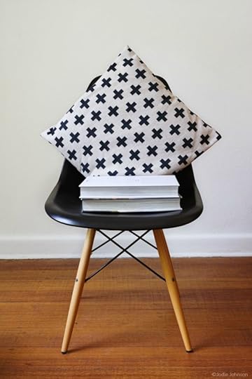 Black chair with black and white pillow and stack of books - photo copyright Jodie Johnson