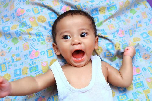 Surprised baby, mouth agape.