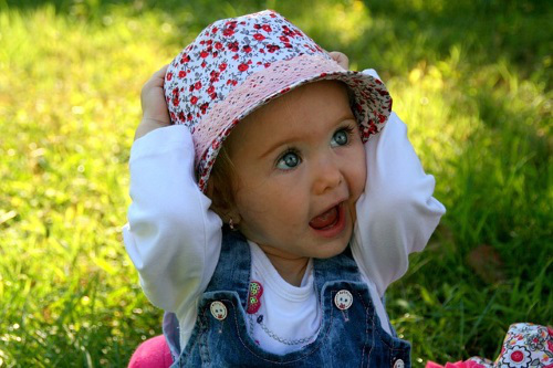 Shocked baby, hands on head.