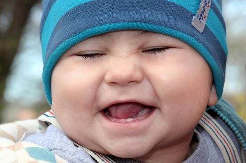 Happy baby, eyes closed.