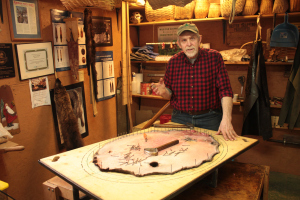 Nailing the skin out to dry. (Photo: Richard Conniff)