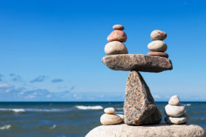 Concept of harmony and balance. Balance stones against the sea. Rock zen in the form of scales