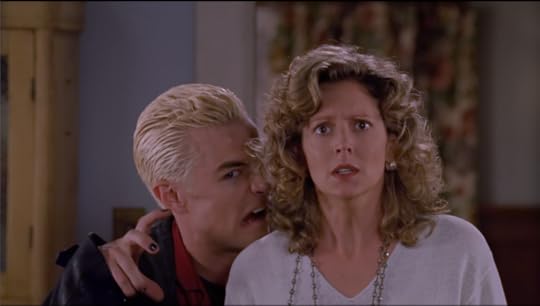 Spike stands behind Joyce, taunting Angel by making a goofy vampire face and a claw hand.
