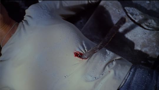 Cordy's midsection, covered in plaster dust, impaled on a piece of rebar.