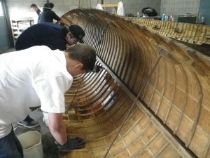 students restoring canoes in penticton