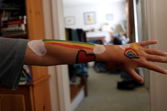 SteelyKid's arm, covered with rainbows that she mostly painted herself.