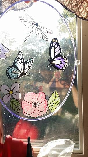 Suncatcher on oval plexiglass background with flowers, leaves, butterflies, and a dragonfly - 3rd place winner, Ozarks Writers League Art Contest