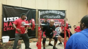 John Greaves III squatting