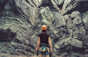 Climber Standing In Front Of A Rock