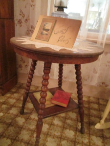 This table, with a crocheted doily, reminds me of one I have. Only mine have the claw feet holding glass balls.