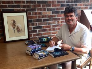 Edward Willett donating books to Butler Library