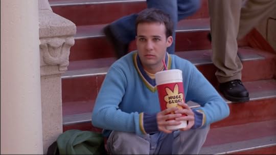 It's Jonathan, a nerdy little guy drinking a giant soda on the steps in the courtyard. He looks super confused at being the center of attention/butt of the joke.