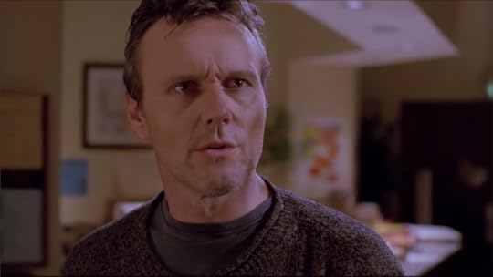 Giles is still in the library, but his glasses are off and he has stubble, so...