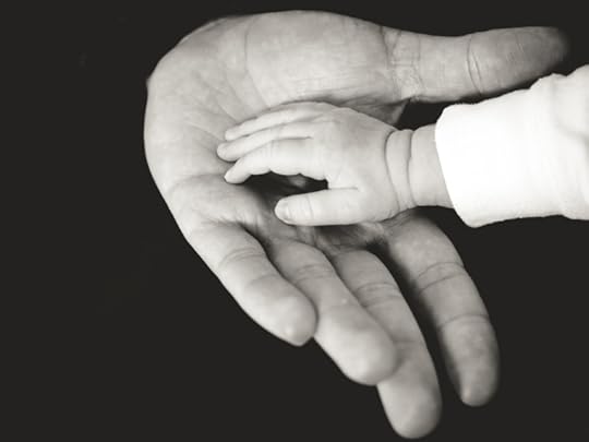 child's hand in parent's hand