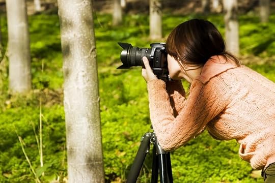 3933538 - young pretty female photographer in a forest.
