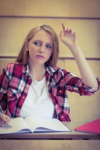 Unsure student raising the hand during class at the university