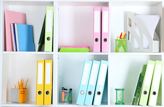 24292303 - white office shelves with folders and different stationery, close up