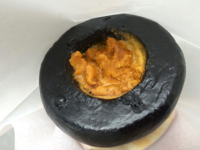 Two types of sea urchin in charcoal bun.