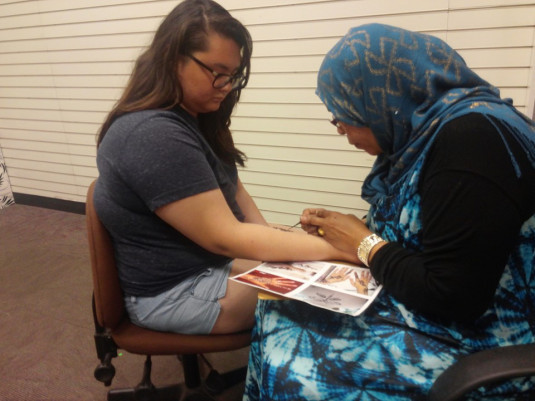 Bri getting henna tattoo