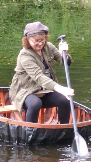 Debbie paddling a coracle