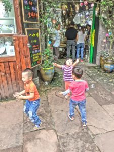 Ancient village with modern kids and bubbles.