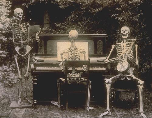 Three skeletons at the piano