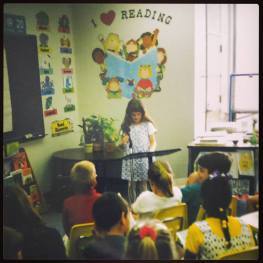 Little Shannon reading her first book to her elementary class. (I bet I reevaluated myself back then, too.)