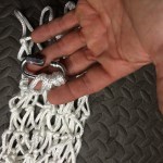 Put loops from the bottom of the net in the chain link