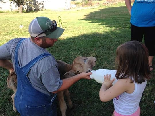 Shane McCubbin feeding Lucky, the Two-Faced Calf