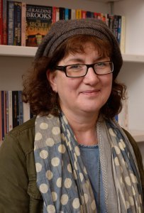 Headshot of Debbie in a bookshop