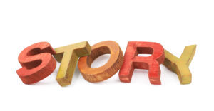 Word Story made of colored with paint wooden letters, composition isolated over the white background