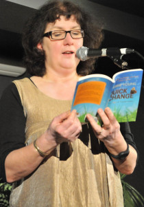 Debbie Young at microphone reading Quick Change