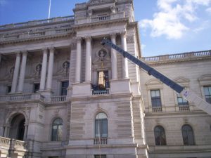A crane hoists a specially designed map encasement into the Library’s Thomas Jefferson Building. Photo by Dianne van der Reyden.