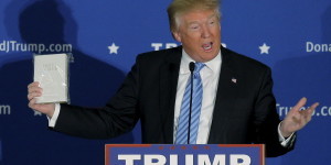 U.S. Republican presidential candidate Donald Trump holds a Bible given to him by an audience member at a campaign rally in Windham