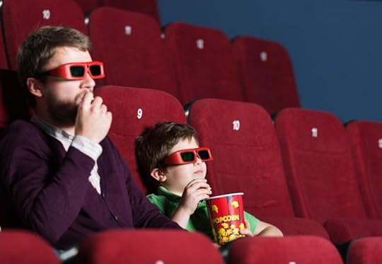 13703302 - a boy with father eating popcorn in 3d movie theater