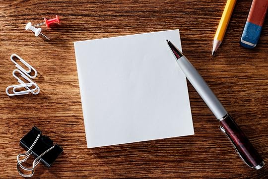 34864131 - assorted office supplies on wooden table, emphasizing white blank notepad at the center with copy space for texts.