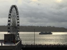 Seattle storm lull with ferris wheel and ferry
