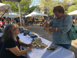 Mrs. Leake buying my book.