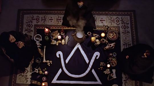Amy, Willow, and some random other witch sitting around a large arcane symbol printed on black cloth. All around the edges are witchy things like various bones and candles and mushrooms and stuff in a mortar and pestle.