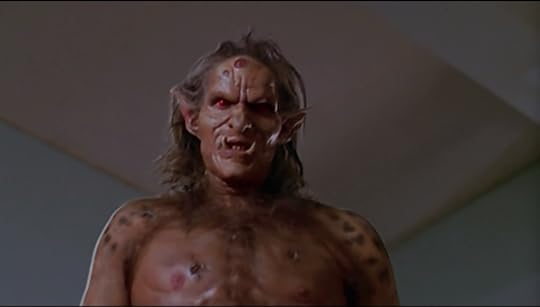 A giant humanoid monster with pointed ears, red eyes, a fanged underbite and lots of open sores.