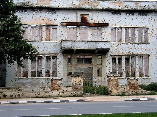 Bullet marked building in Huambo, Angola. Image via Wikipedia.