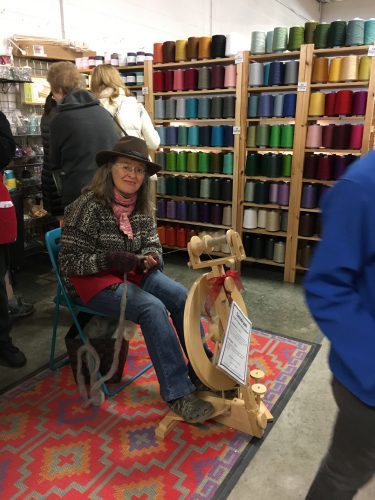 a happy spinner trying out a Lendrum wheel