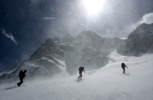 High winds batter our ski group as we climb. 